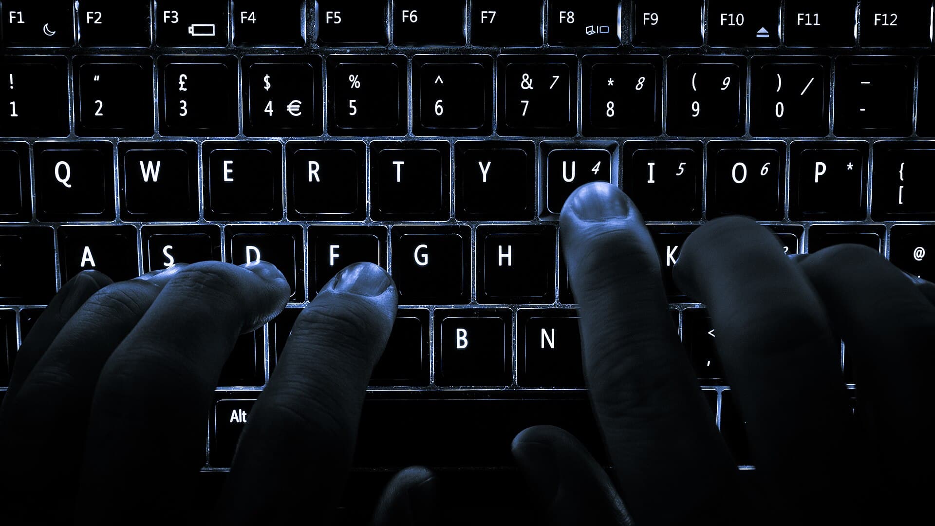 Backlit keyboard in low light, illustrating the layered tools of a complete anonymity stack